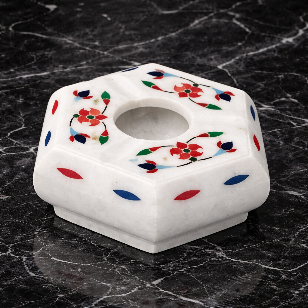 0.353 gm Handcrafted white marble hexagon ashtray with red floral stone inlay on black marble surface