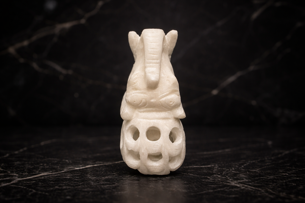 Top view of decorative marble elephant figurine elephant inside elephant design on black surface