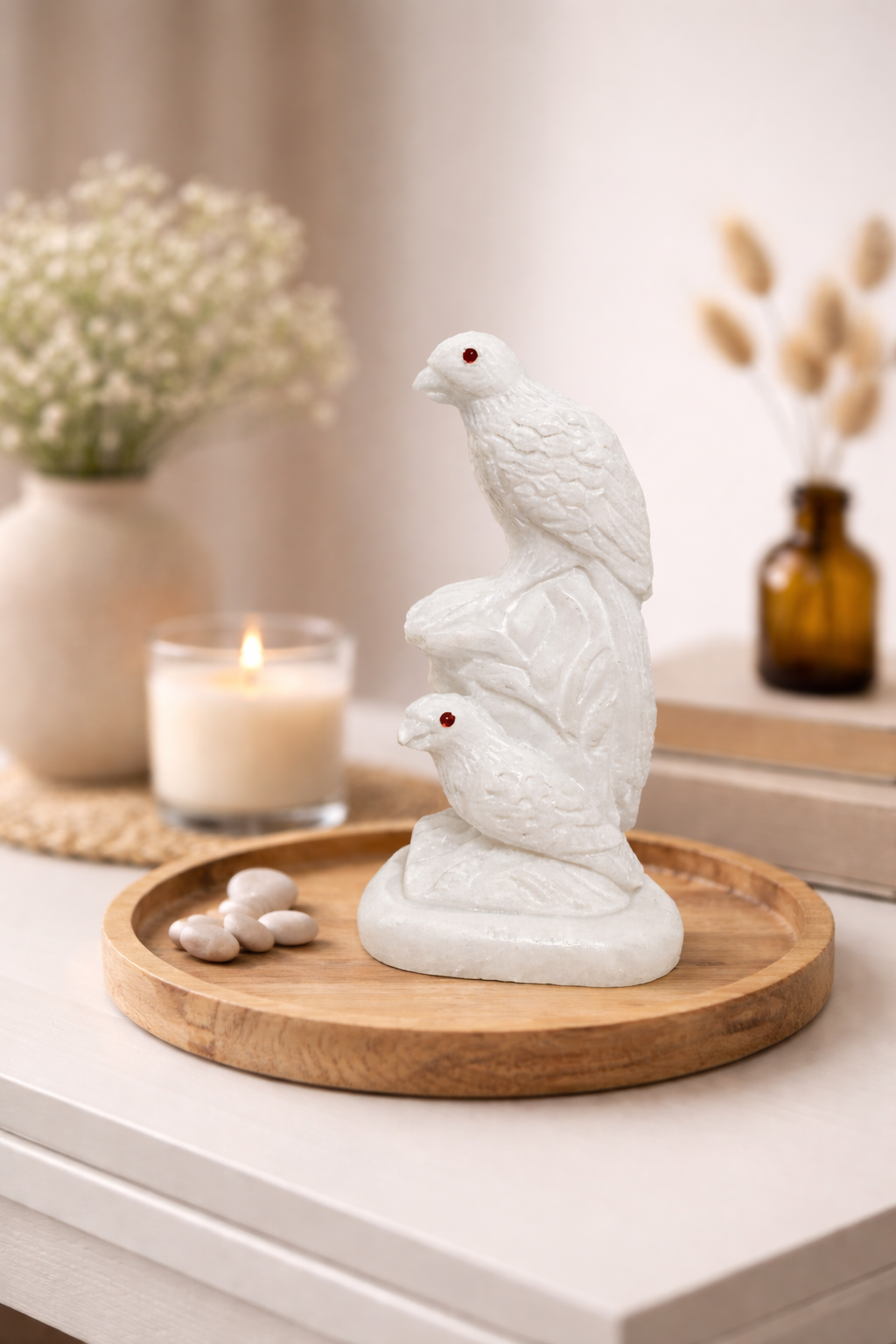 Hand-carved white marble bird sculpture with red gemstone eyes on wooden tray – luxury home décor NZ