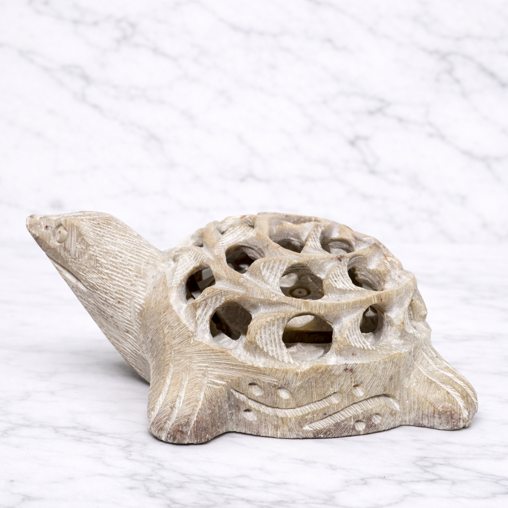 Side view of White marble turtle décor ornament with carved shell design