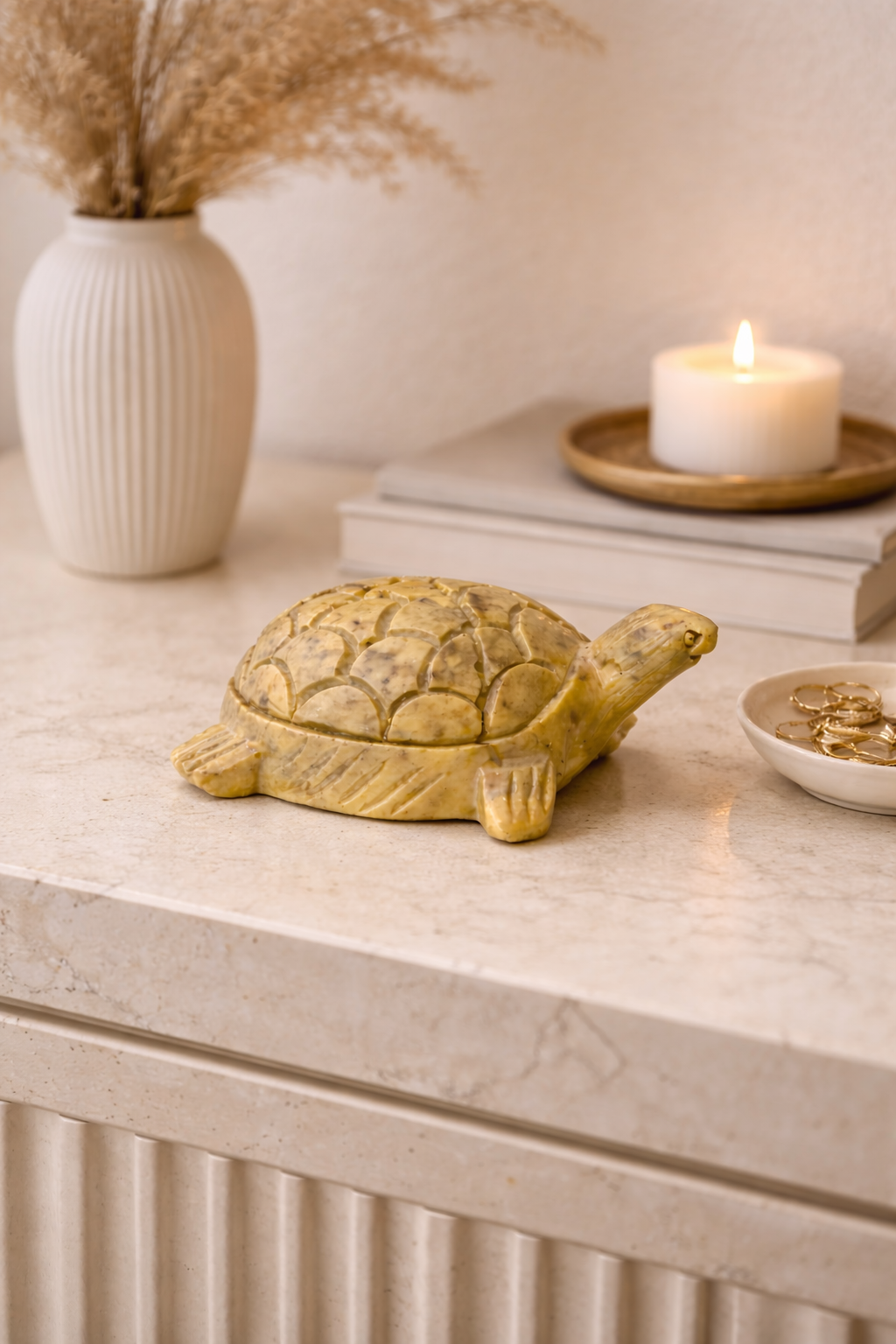 0.374 kg Polished soapstone turtle sculpture styled on console table with candle and books
