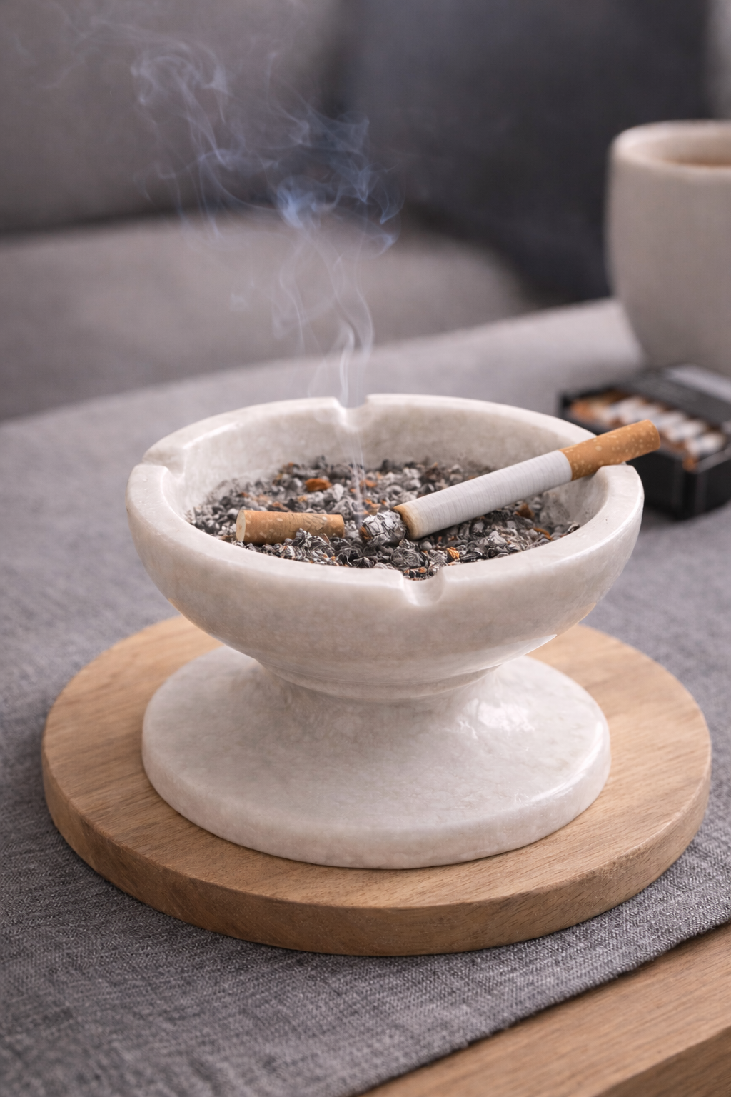 White marble pedestal bowl styled as minimalist stone ashtray on tabletop