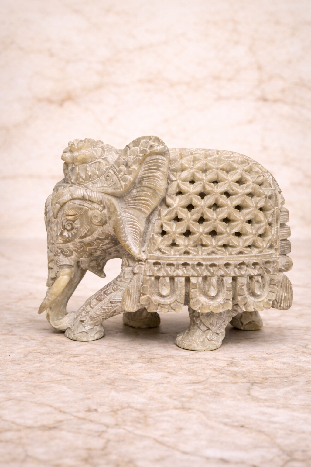 Handcrafted soapstone elephant statue with inner elephant carving symbolising protection and unity