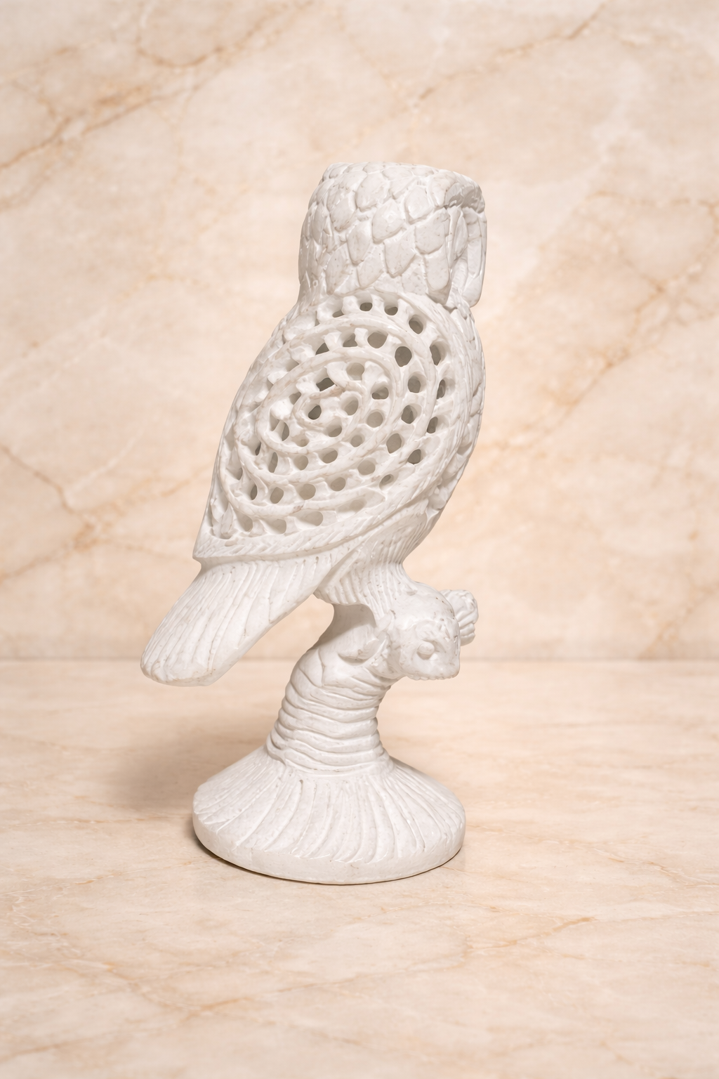 Side view for Hand-carved white marble owl sculpture perched on branch