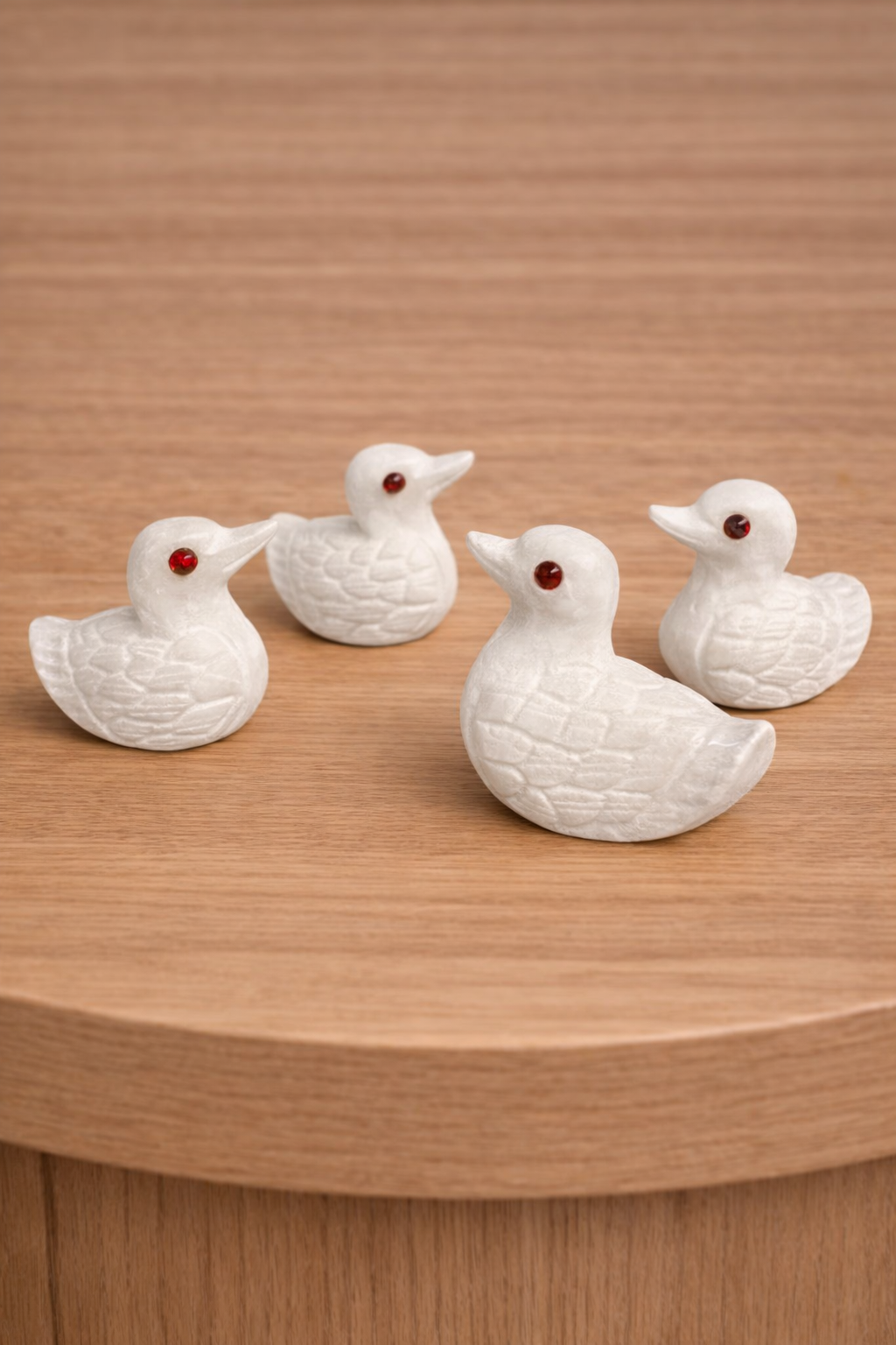 Four hand-carved white marble duck figurines
