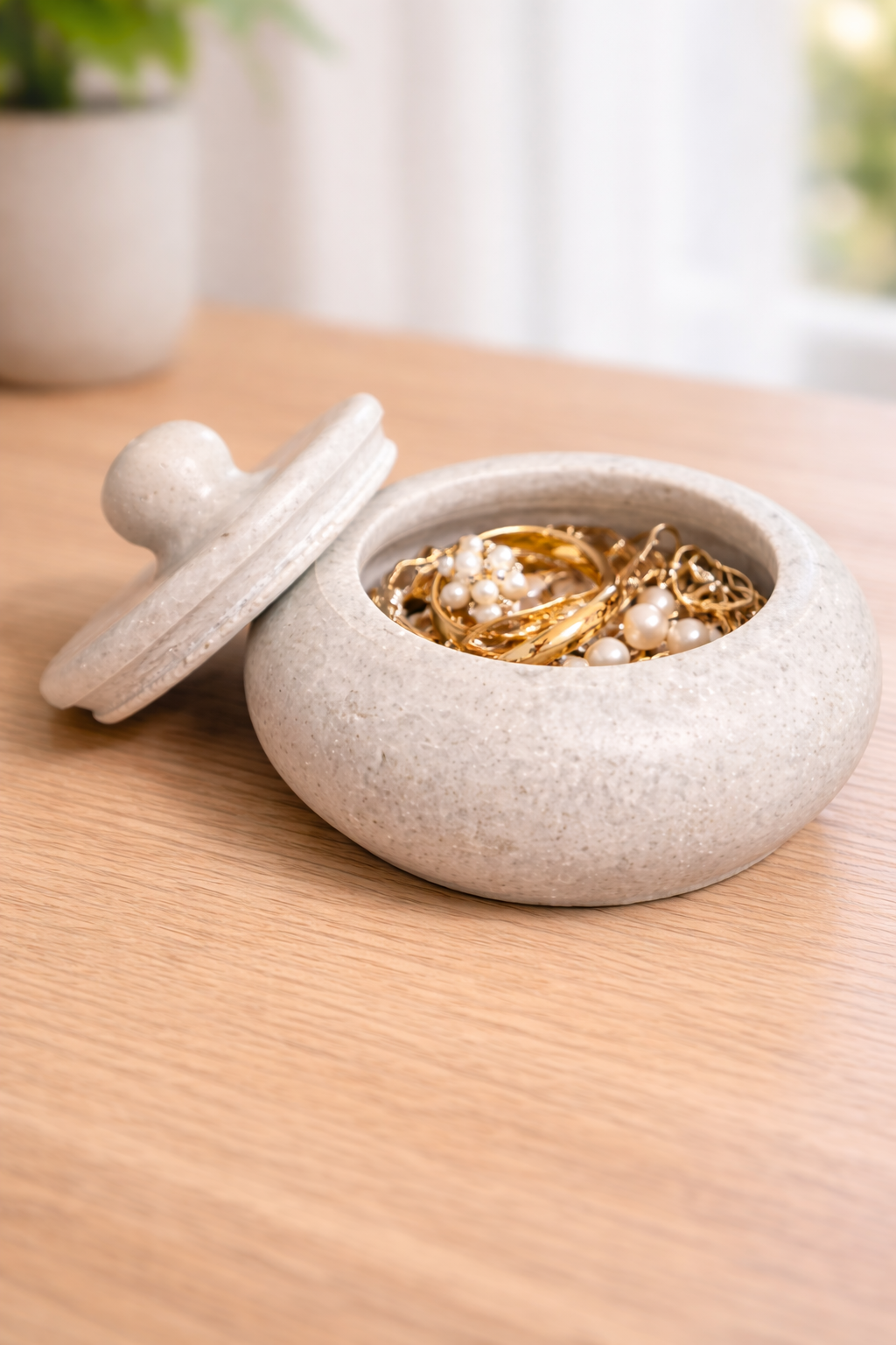 White marble trinket bowl with lid used as jewellery and ring holder in modern home