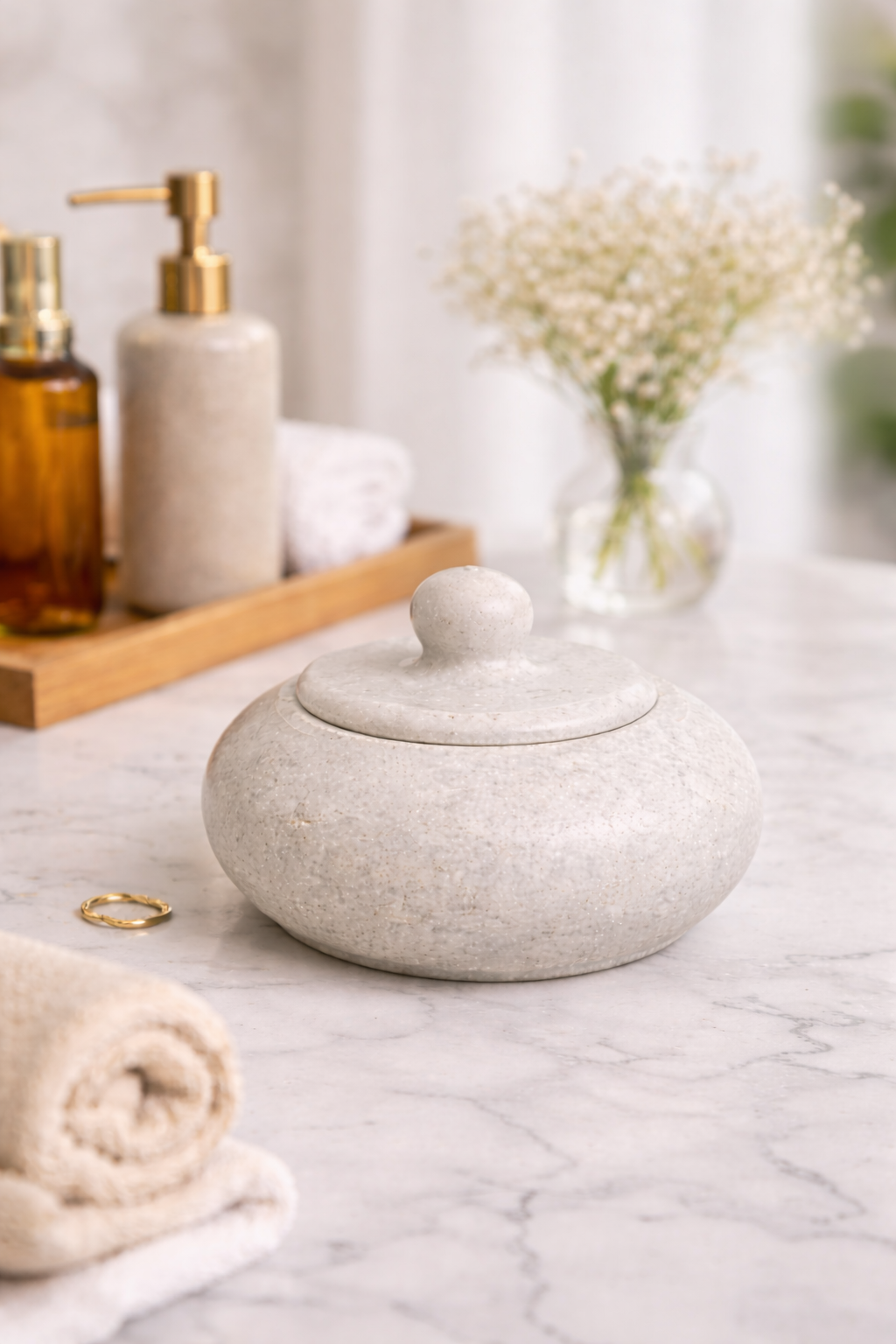 Natural white marble bowl with lid styled on bathroom vanity as luxury storage container