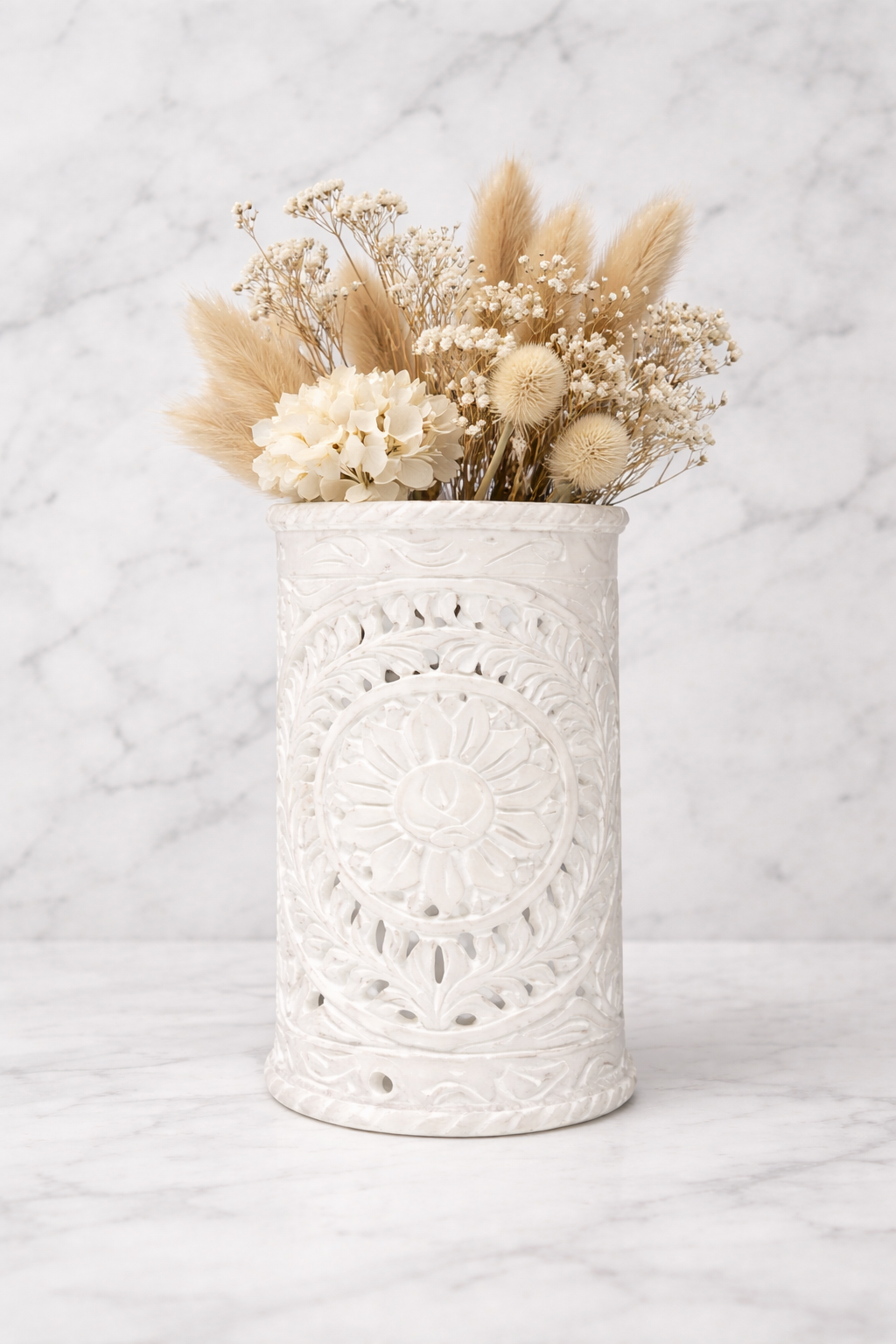 Hand-carved white marble decorative vase with dried flowers