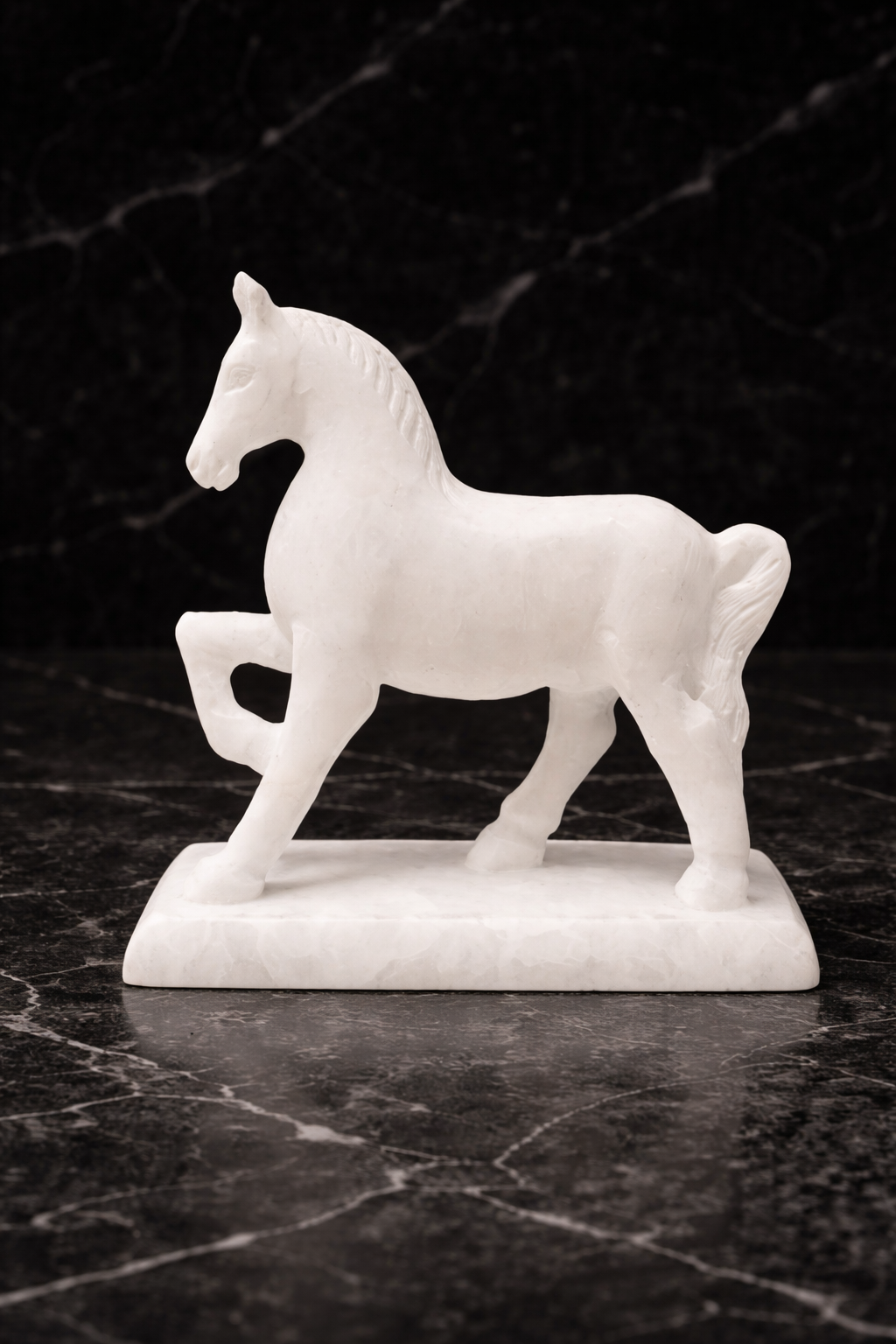 White marble horse sculpture on stand displayed on black marble surface
