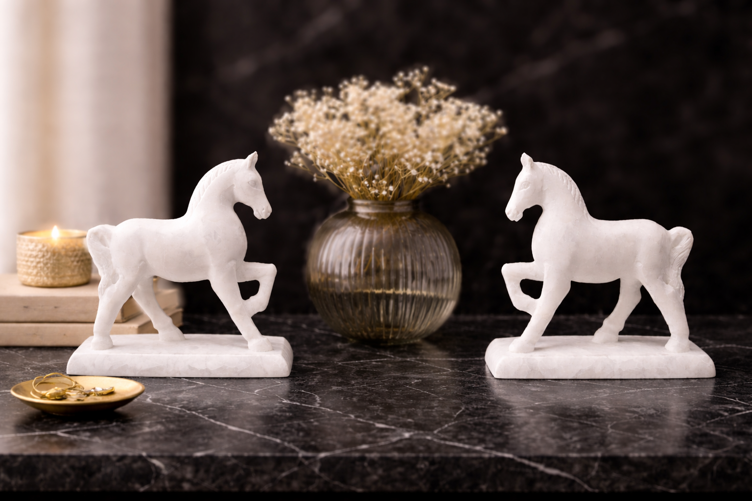 White marble horse sculpture pair styled on console with decorative tray and flowers