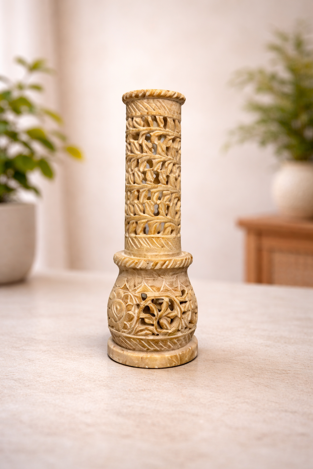Soapstone incense burner tower for sticks or cones on white marble tabletop