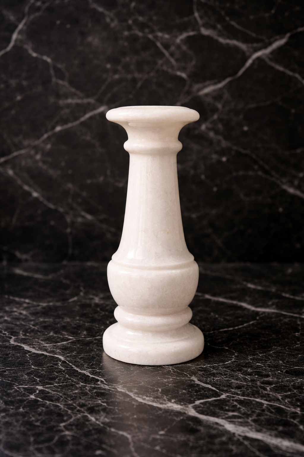 White marble candle holder styled on black marble