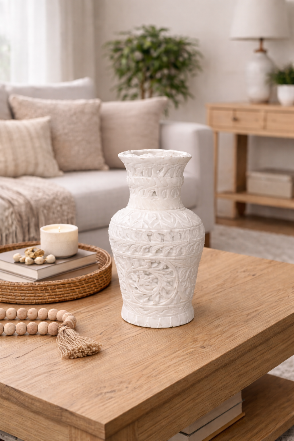 Hand-carved white marble decorative vase on wooden coffee table in modern living room setting