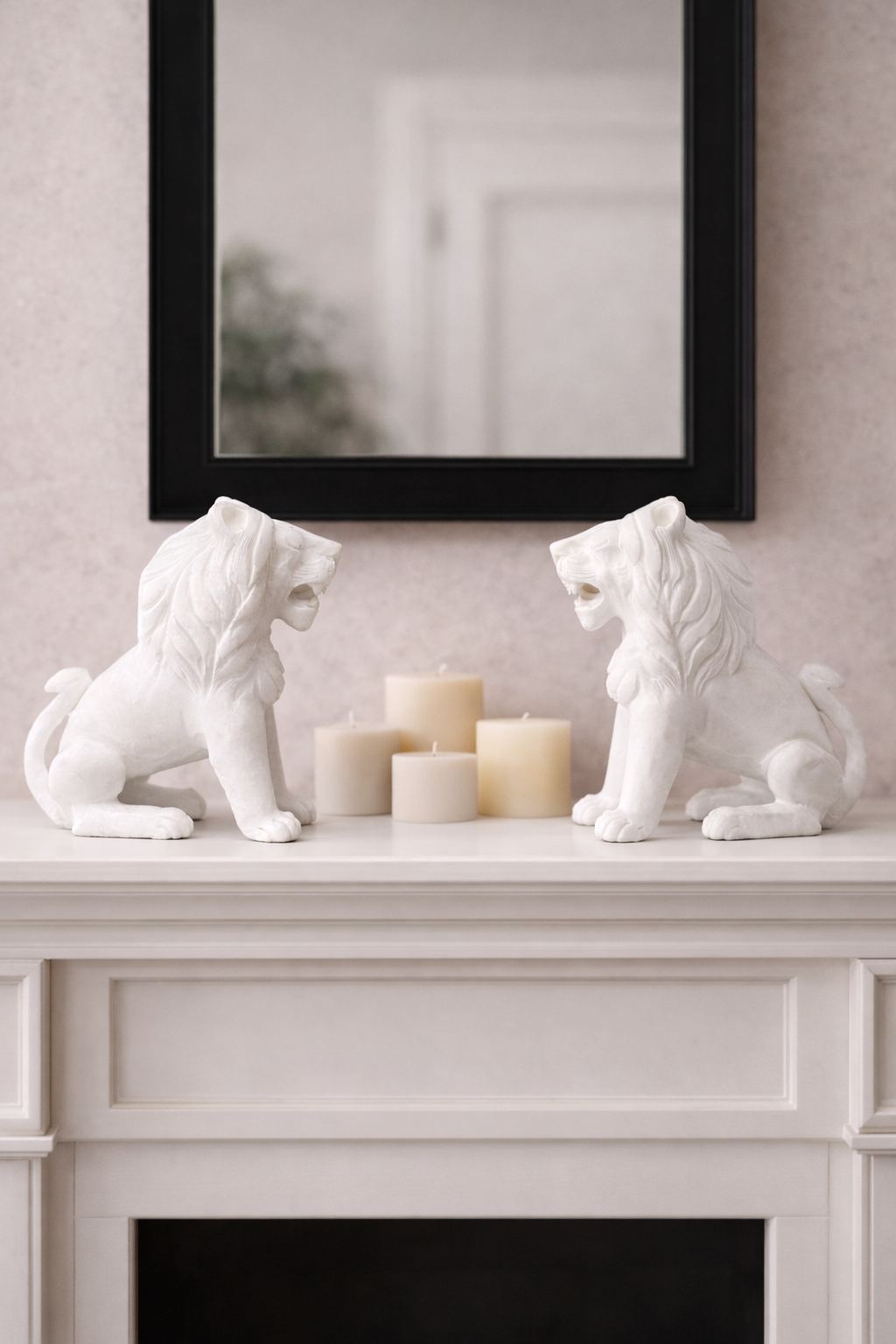 Pair of polished white marble sitting lion sculptures on mantelpiece with candles and mirror