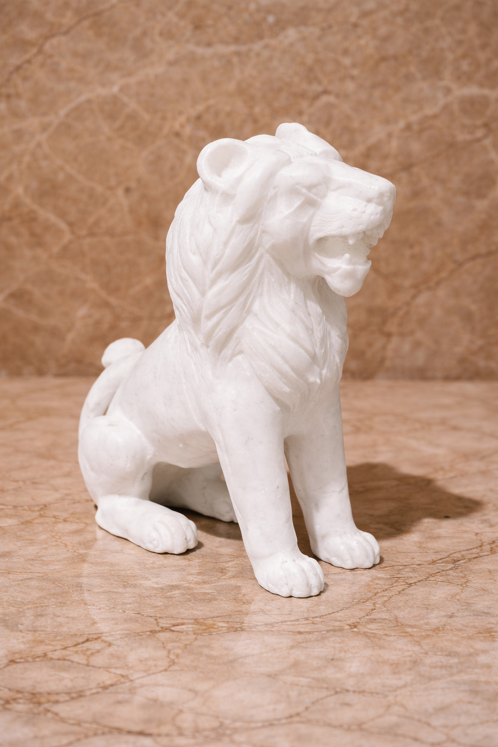 Side view of polished white marble sitting lion sculpture on beige marble surface