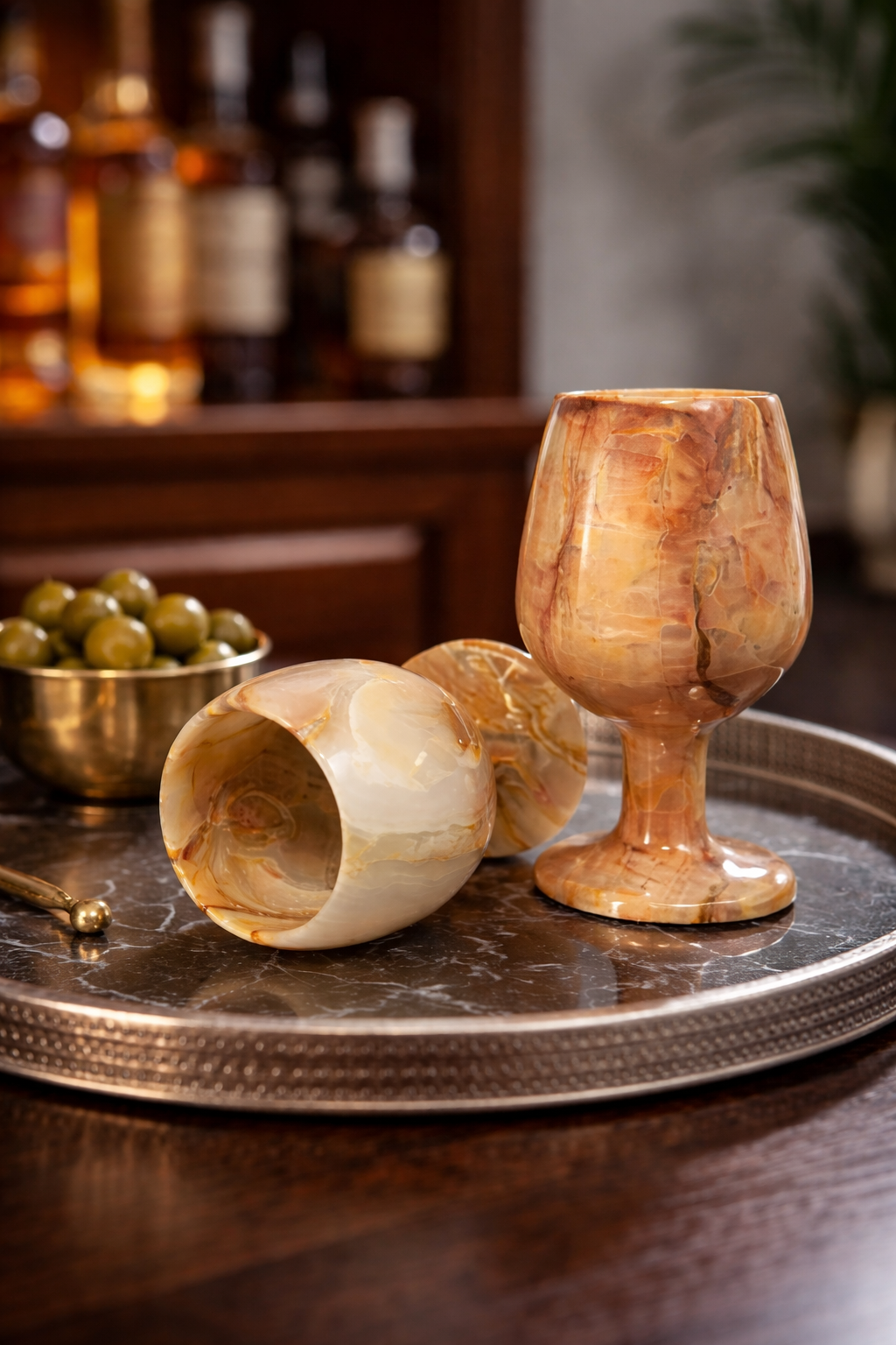 Handcrafted onyx wine glasses styled on luxury home bar shelf