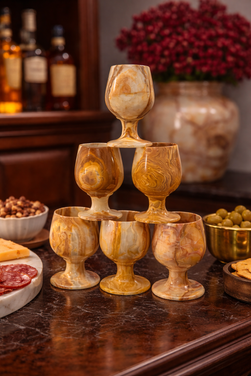 Stone wine goblets arranged on bar counter with nuts and olives