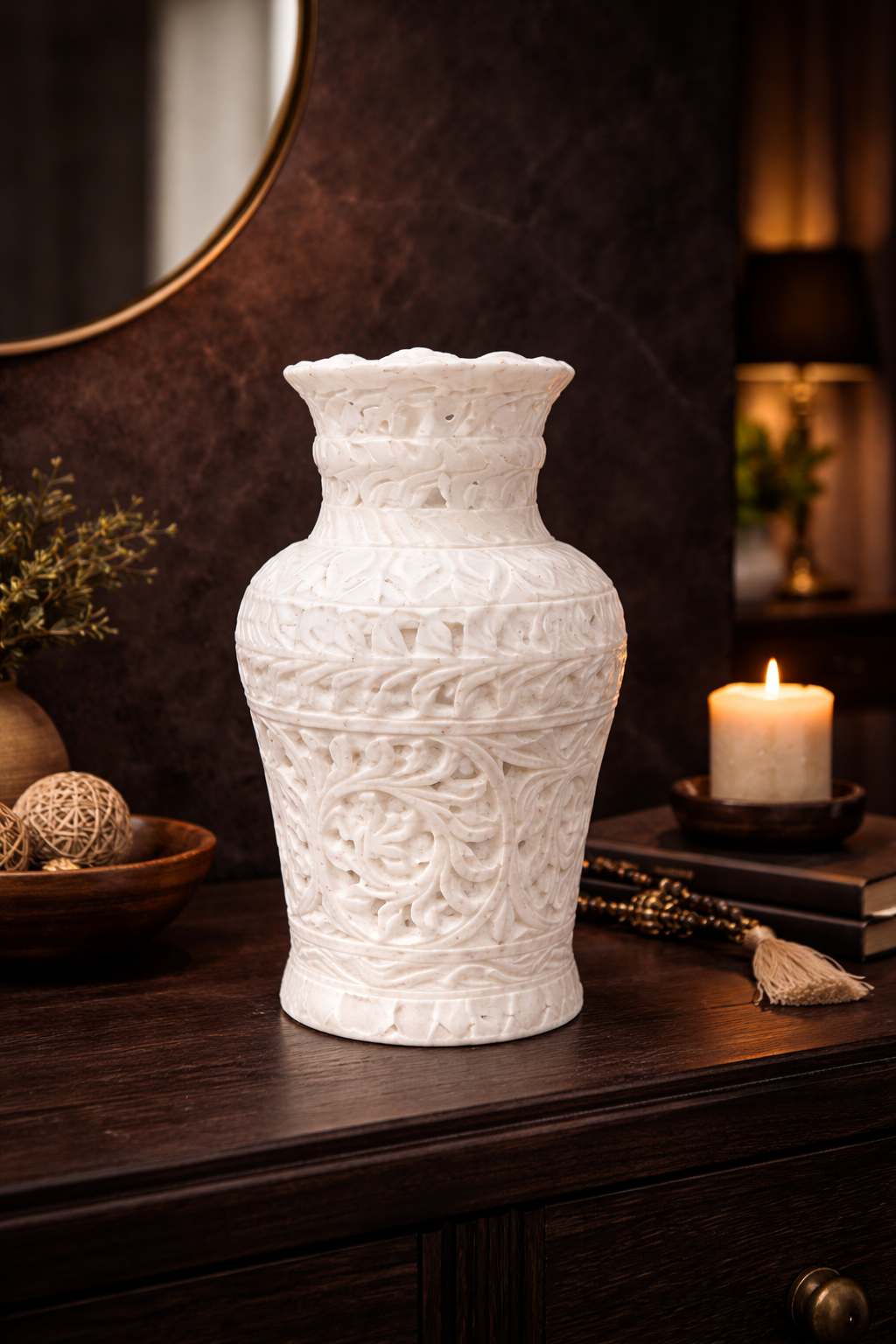 Hand-carved white marble decorative vase on dark wooden console table