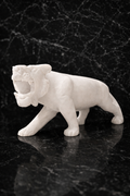 White marble tiger sculpture on black marble console table, luxury natural stone animal decor for modern NZ homes.
