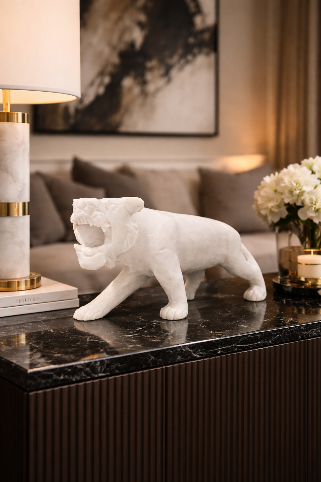 White marble tiger sculpture on black marble console table,