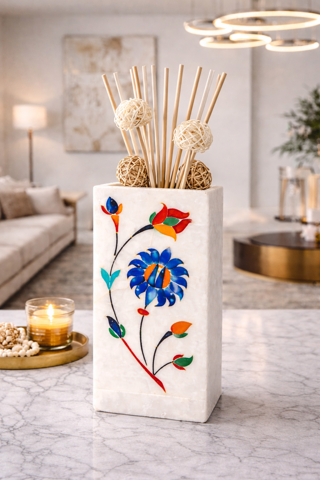 White marble multipurpose stand with handcrafted floral inlay used as reed diffuser holder on marble table