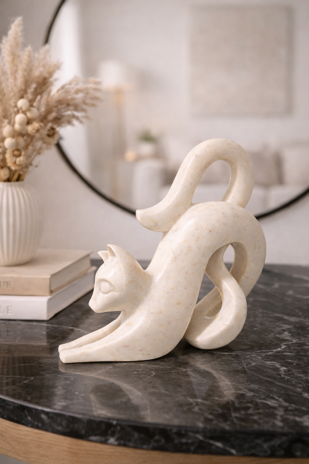 Hand-carved white marble cat sculpture styled on black marble console table, luxury modern home décor NZ