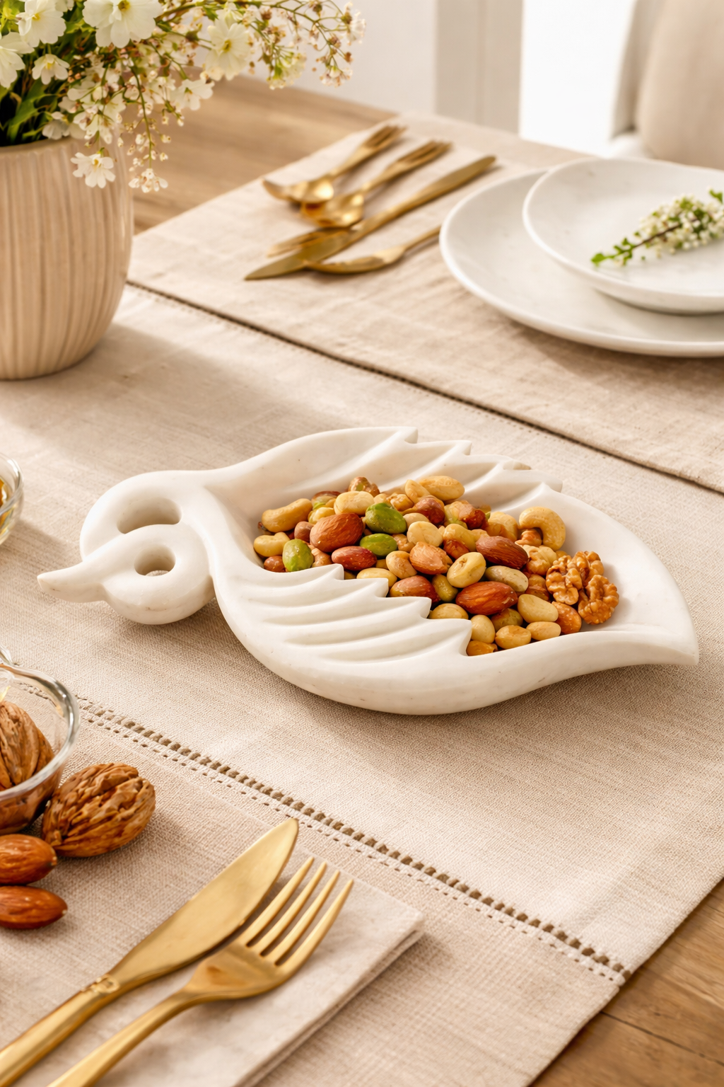 Solid white marble leaf serving bowl filled with mixed nuts luxury dining decor NZ