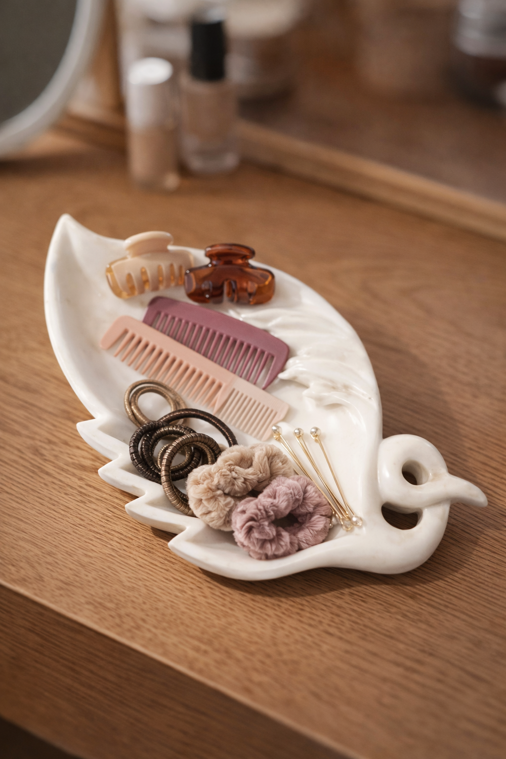White marble leaf bowl used as hair accessories holder on dressing table