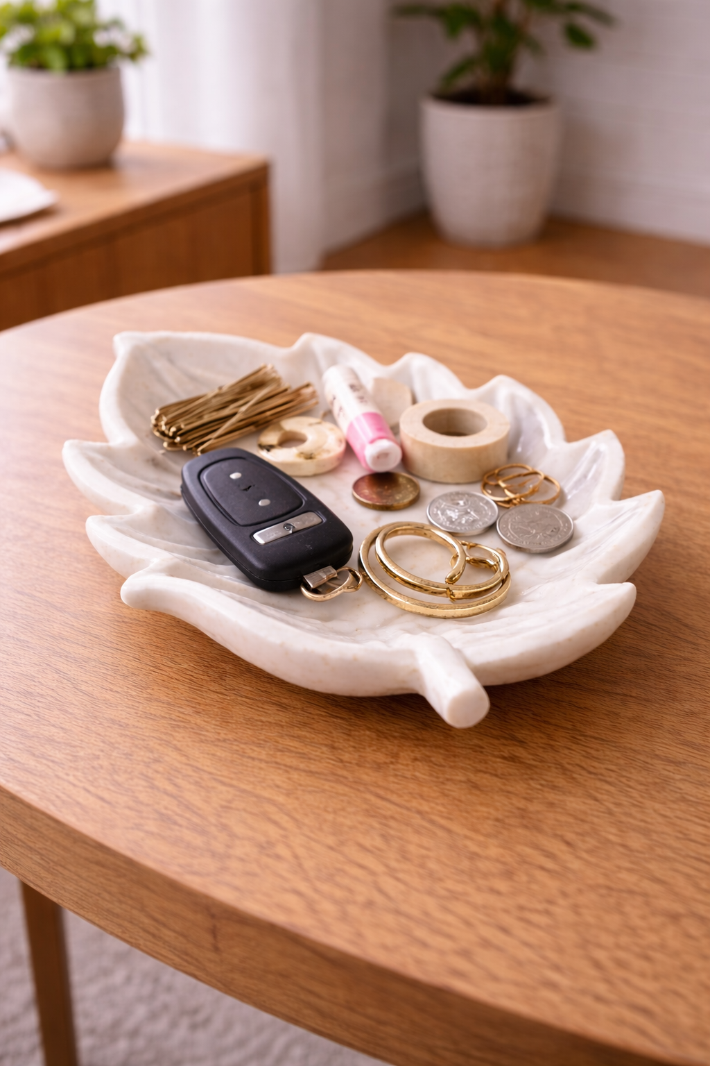 Marble leaf bowl used as a key, jewellery and coin holder on an entry table
