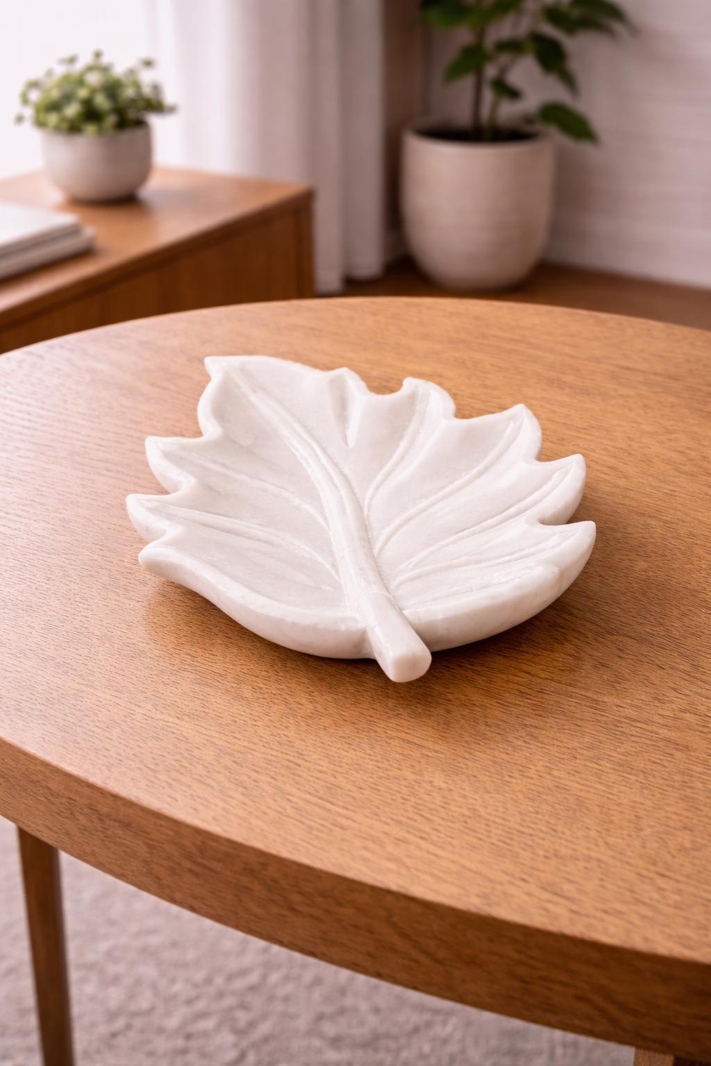 Hand-carved white marble leaf-shaped bowl with polished finish and natural stone veining.