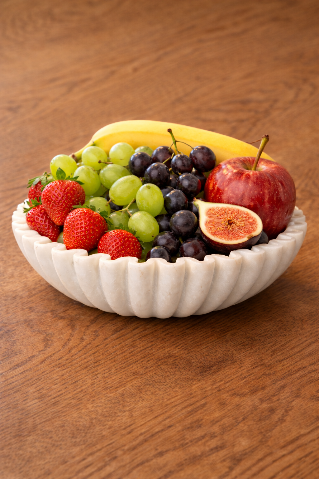Polished white marble fluted bowl styled as fruit holder on wooden table, luxury kitchen décor NZ