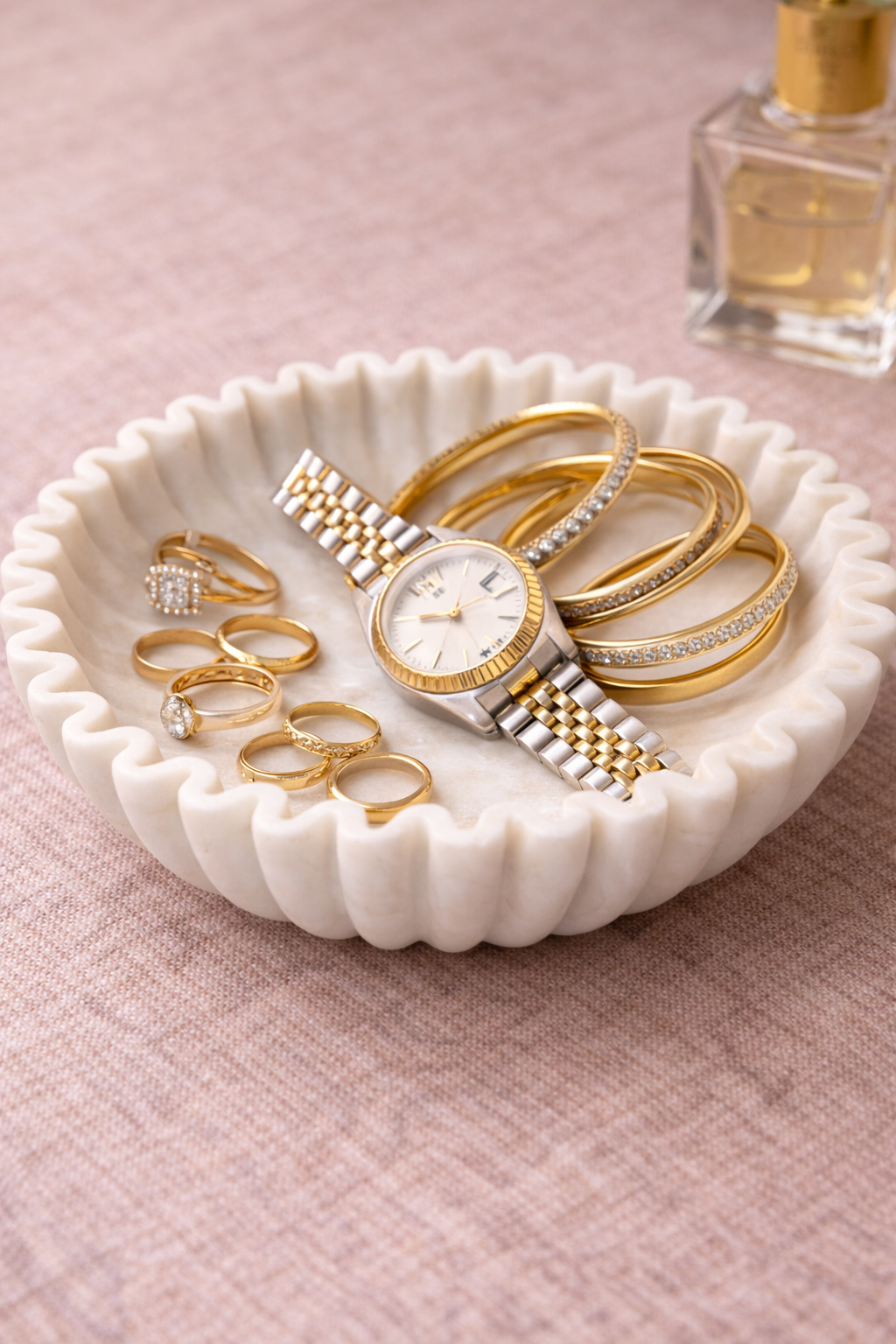 Hand-carved white marble zigzag bowl used as jewellery holder on wooden table, luxury stone décor NZ