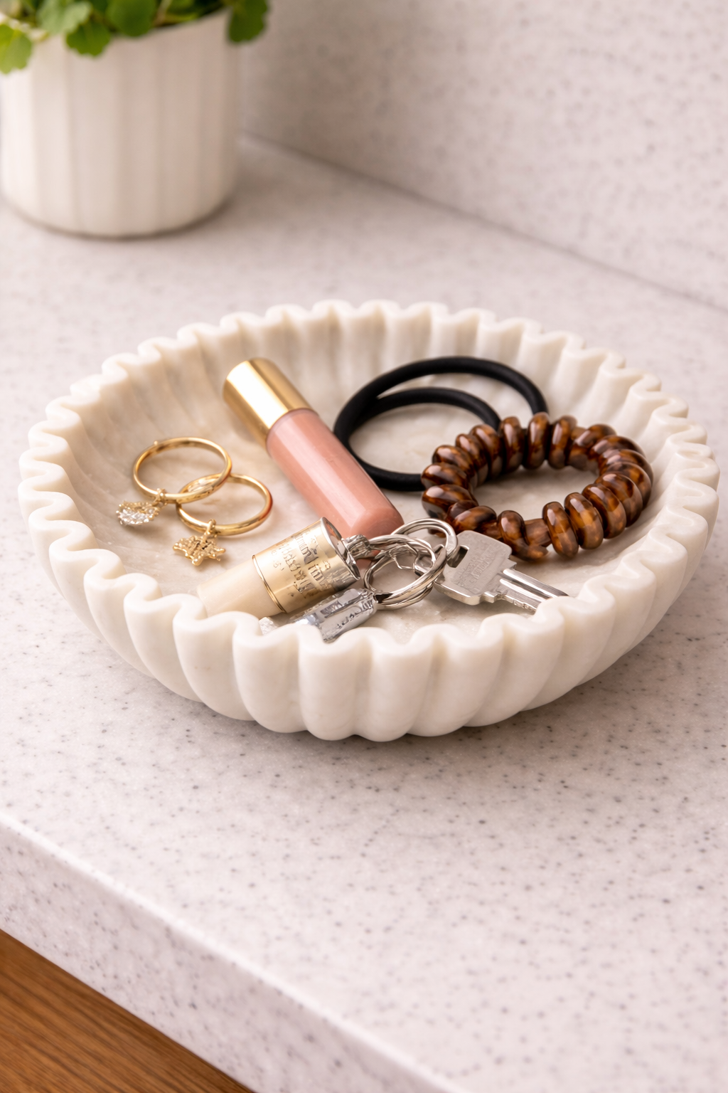 Polished white marble fluted bowl holding hair accessories on console table, elegant home organiser NZ