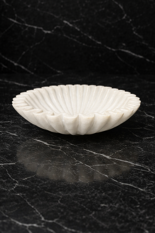 Hand-carved white marble zigzag decorative bowl on black marble surface, luxury stone home décor NZ
