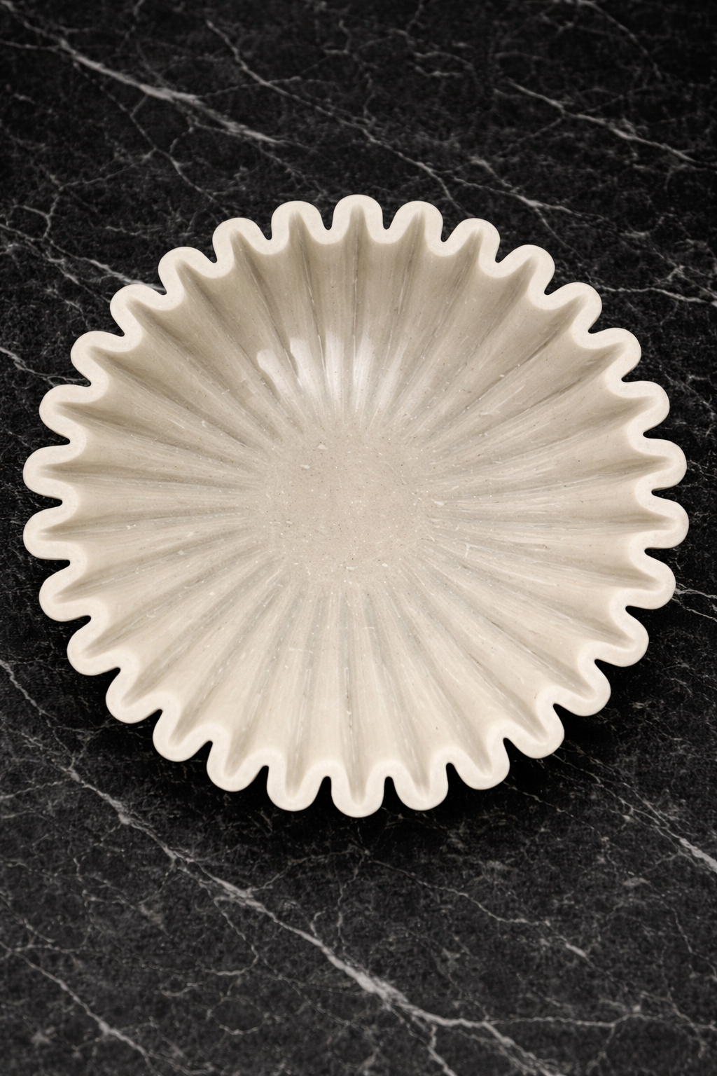 Polished white marble fluted bowl with zigzag rim on black marble table, premium decorative centrepiece NZ