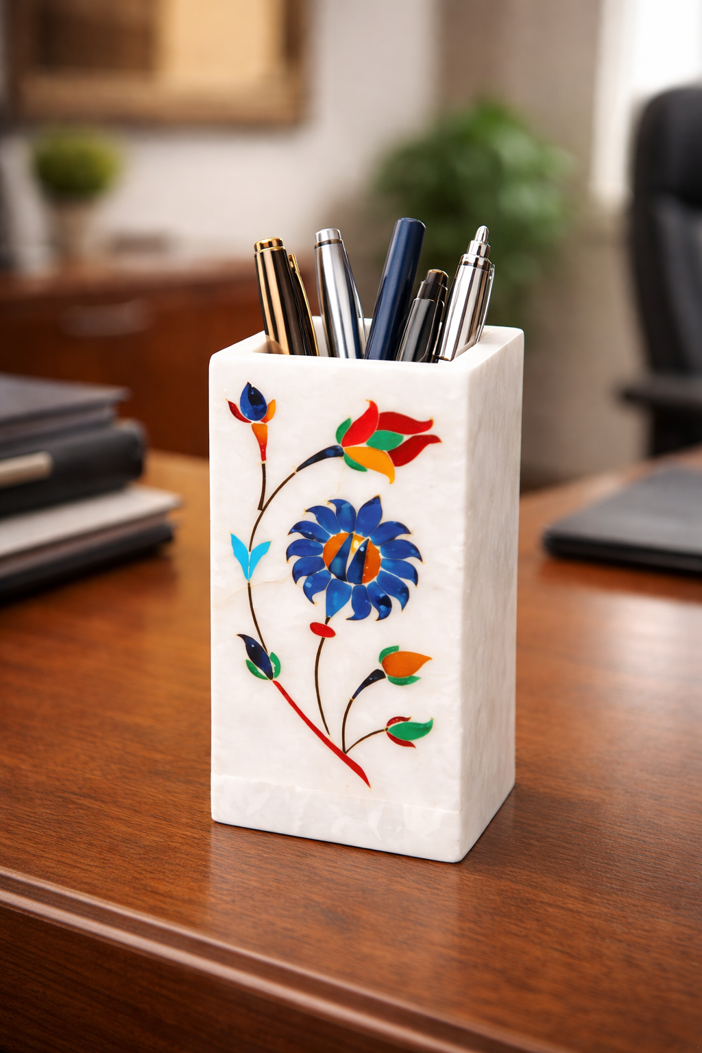 Handcrafted white marble multipurpose stand with colourful floral inlay design used as a pen holder on a wooden desk in NZ home office