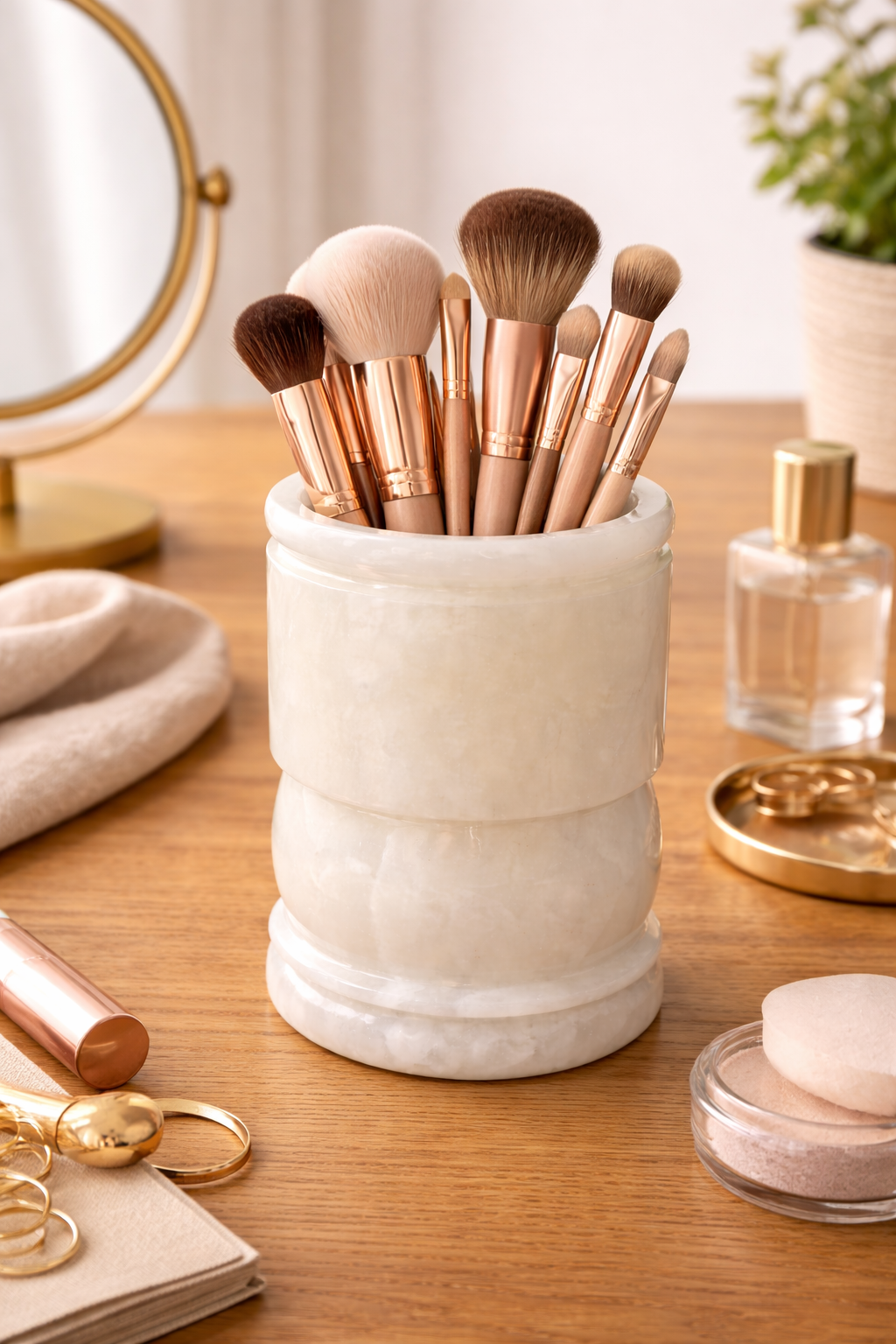 Natural onyx vanity holder with makeup brushes in a minimalist beauty space.