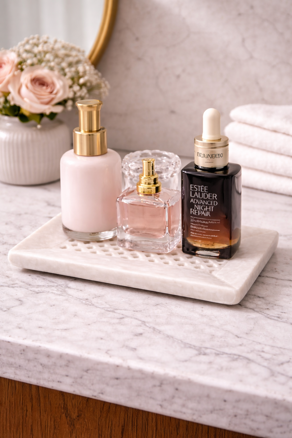 Natural marble tray styled with perfume bottles and skincare products on vanity, premium bathroom decor NZ.