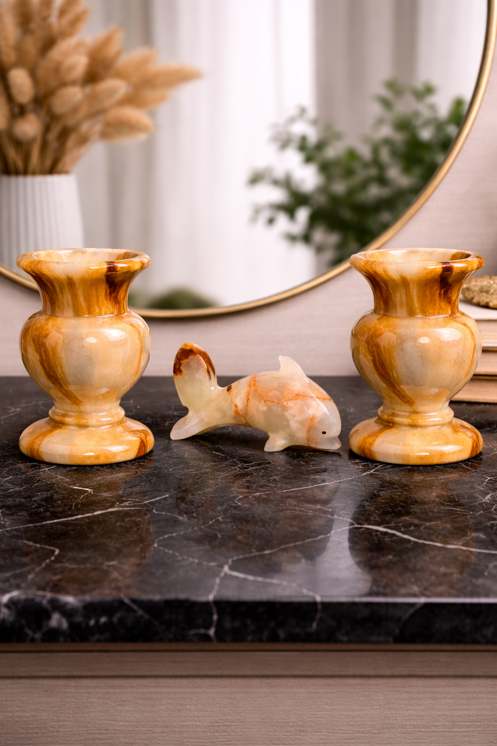 Natural onyx vases styled on marble table with decorative stone fish figurine, luxury home decor centrepiece NZ.