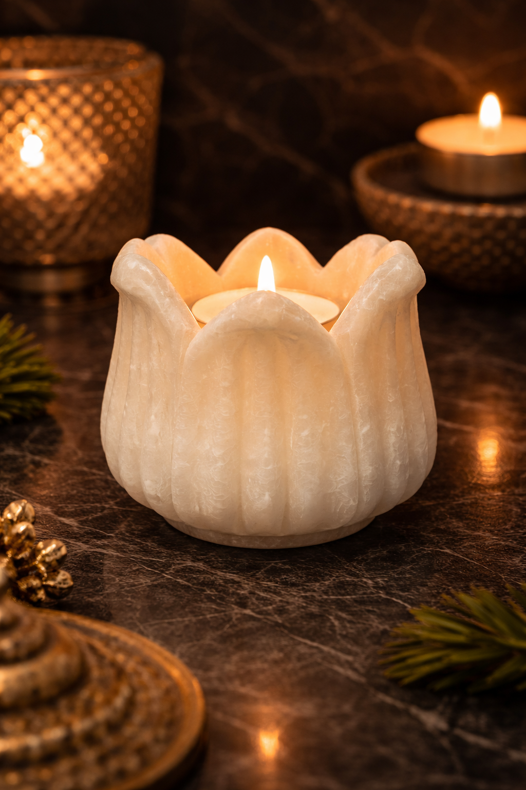 Hand-carved white marble lotus candle holder with lit tealight on dark marble table, luxury home décor NZ