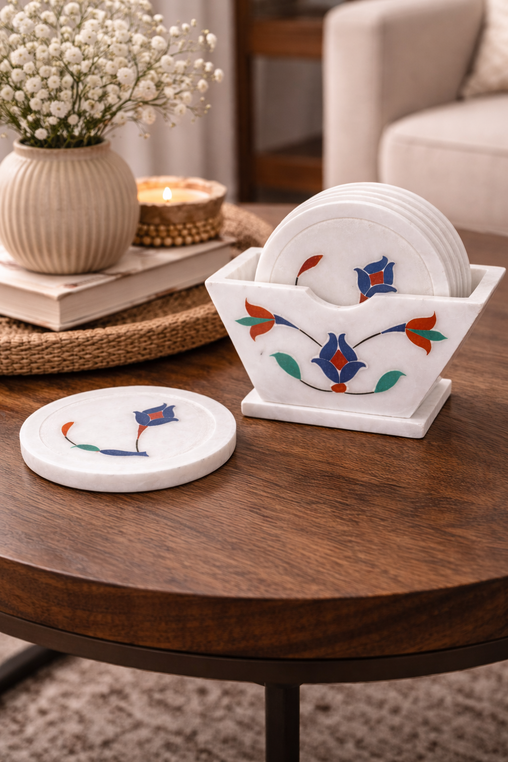 Premium white marble coasters with floral inlay design and matching holder on living room table