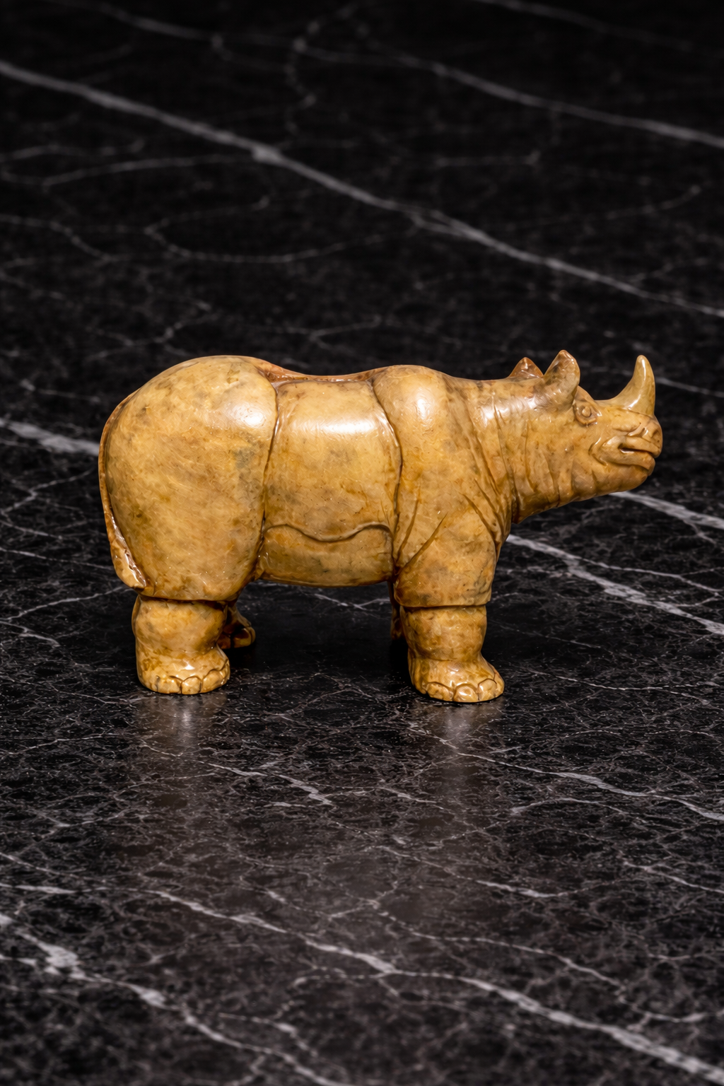 hand carved soapstone rhino sculpture natural stone animal figurine on black marble surface