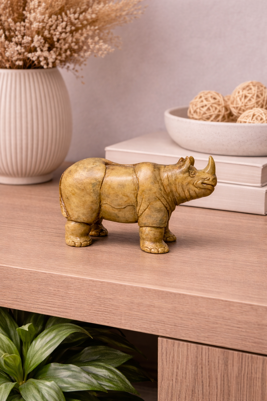 hand carved soapstone rhino sculpture decorative animal figurine on light wood table 