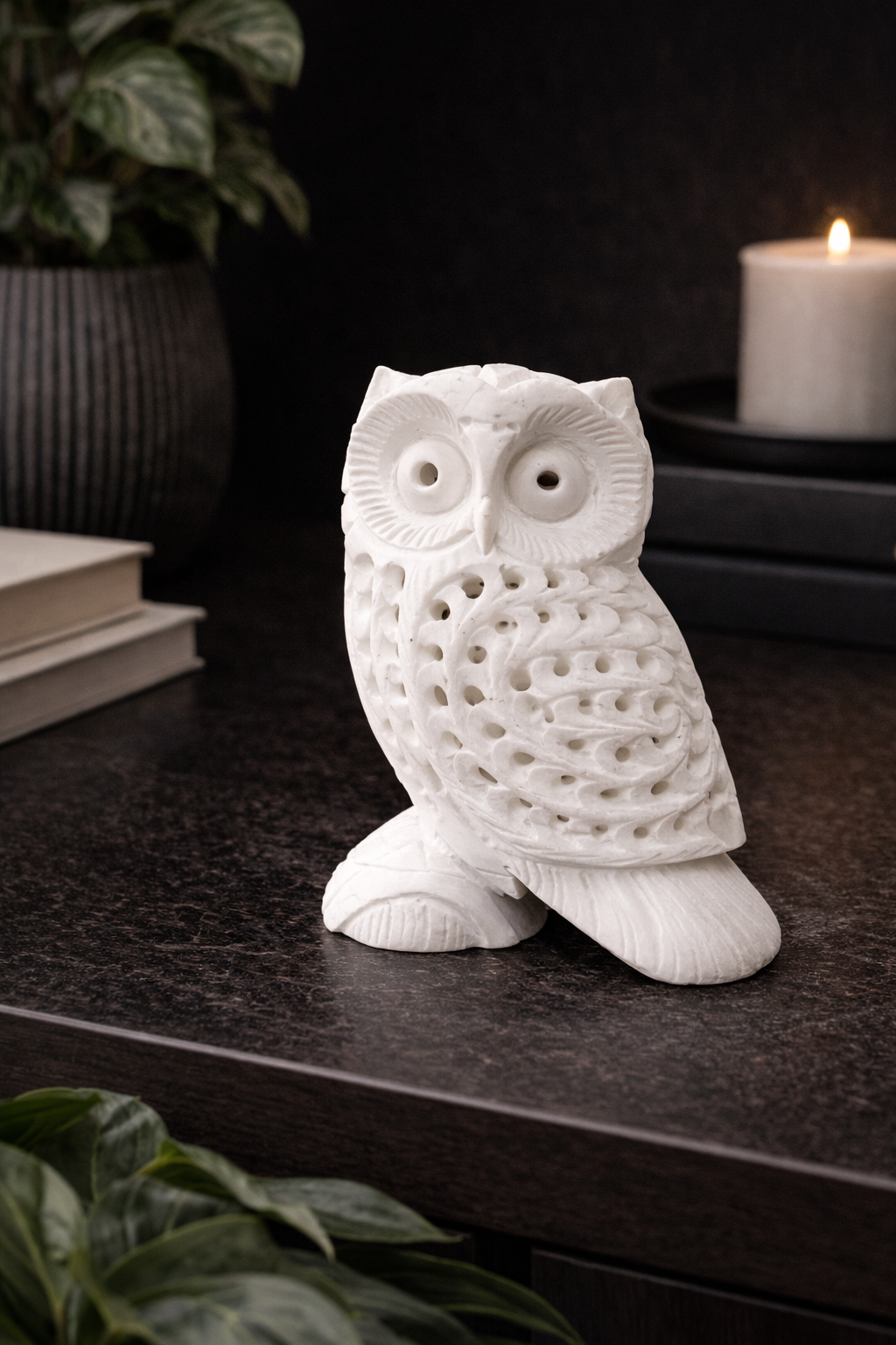 Hand-carved white marble owl sculpture on black marble table with candle – luxury home décor NZ