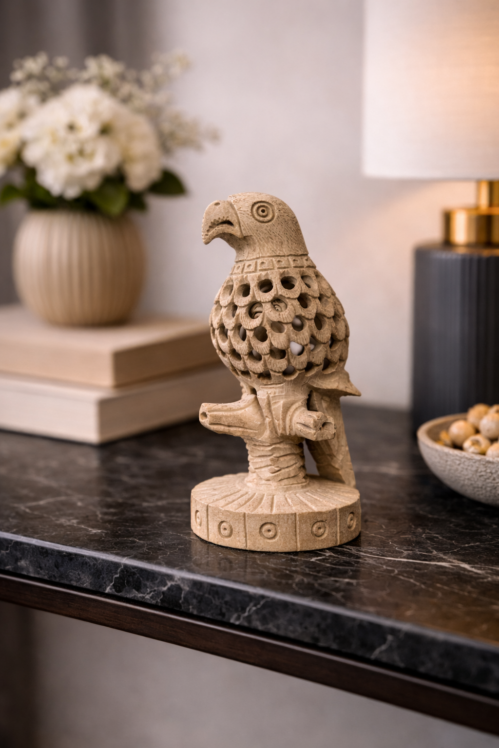 Hand-carved soapstone parrot sculpture displayed on wooden console table in modern home interior