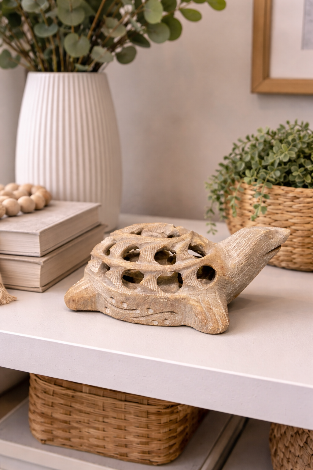 White marble turtle sculpture styled on shelf with indoor plants and books – natural stone home décor