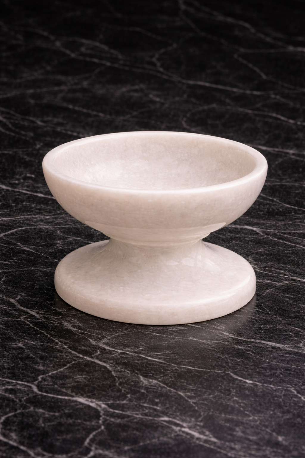 White marble pedestal bowl decorative dish on black marble background for NZ home styling