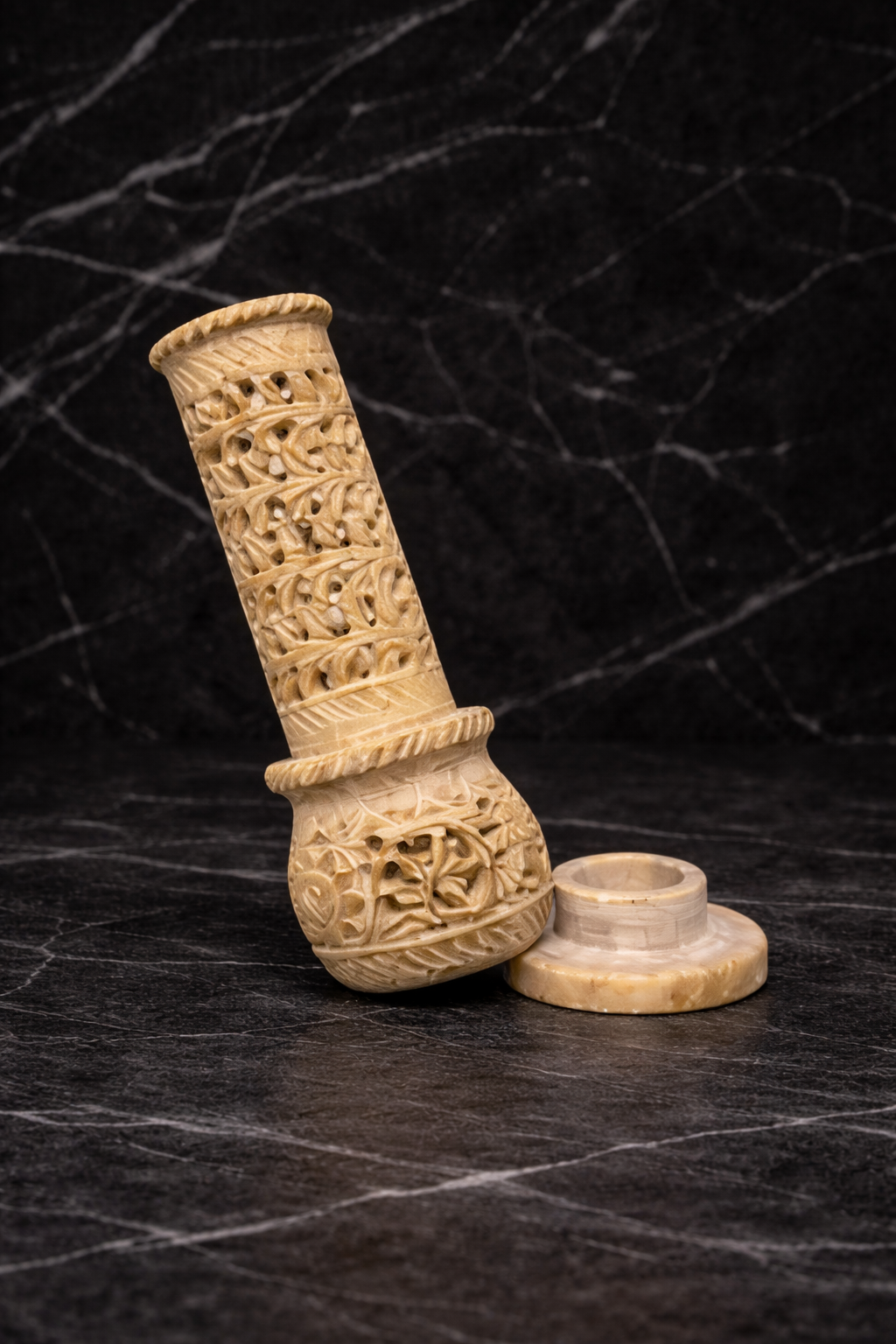 Hand-carved soapstone incense burner tower with holder on black marble surface