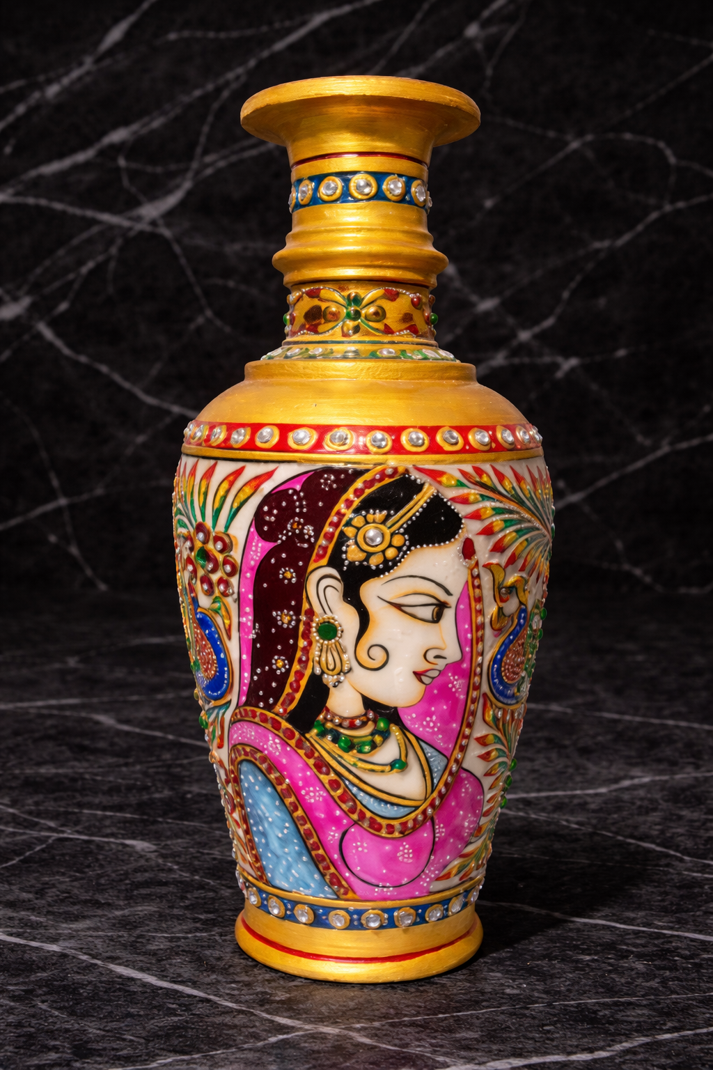 Hand-painted decorative vase with gold accents on a dark marble surface