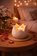 Hand-carved marble lotus tealight holder with candle in a cozy bedroom setting